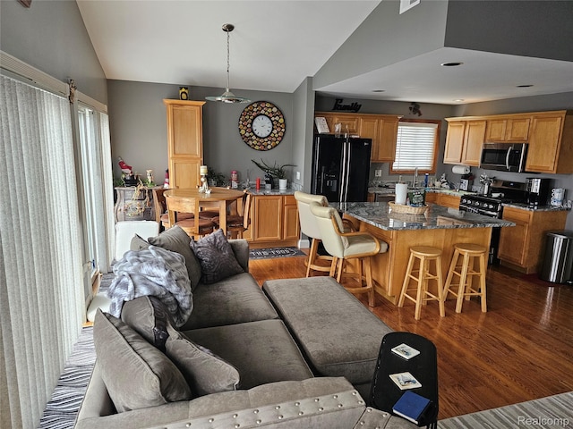 8889 Anchor Bay Dr, Clay, MI 48001 - living room with vaulted ceiling and dark wood-style flooring