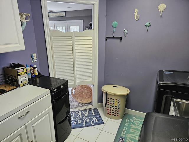 8889 Anchor Bay Dr, Clay, MI 48001 - laundry room with cabinet space, tile patterned flooring, and baseboards