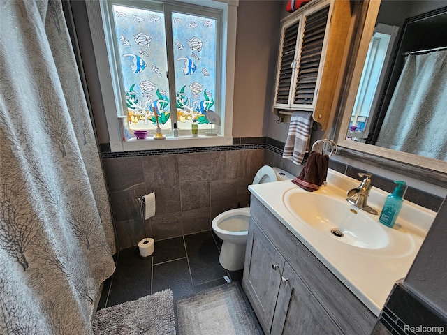 8889 Anchor Bay Dr, Clay, MI 48001 - full bathroom featuring toilet, vanity, tile walls, a wainscoted wall, and healthy amount of natural light