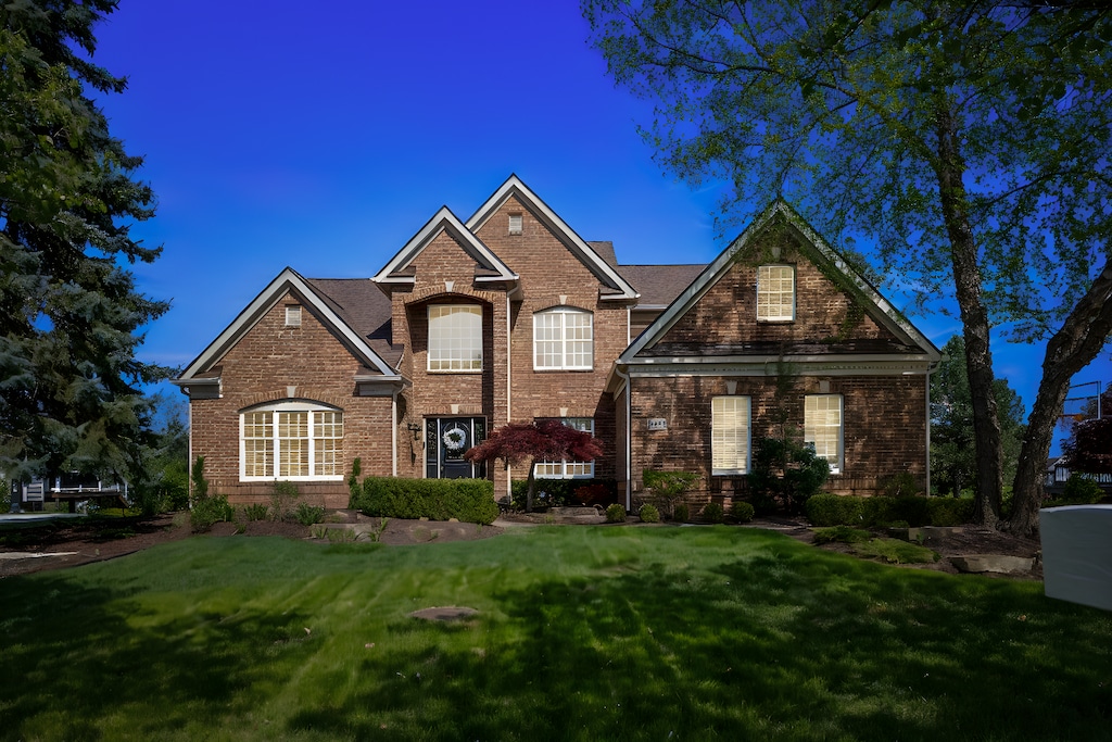 15428 Bay Hill Dr, Northville, MI 48168 - traditional-style house with brick siding and a front yard