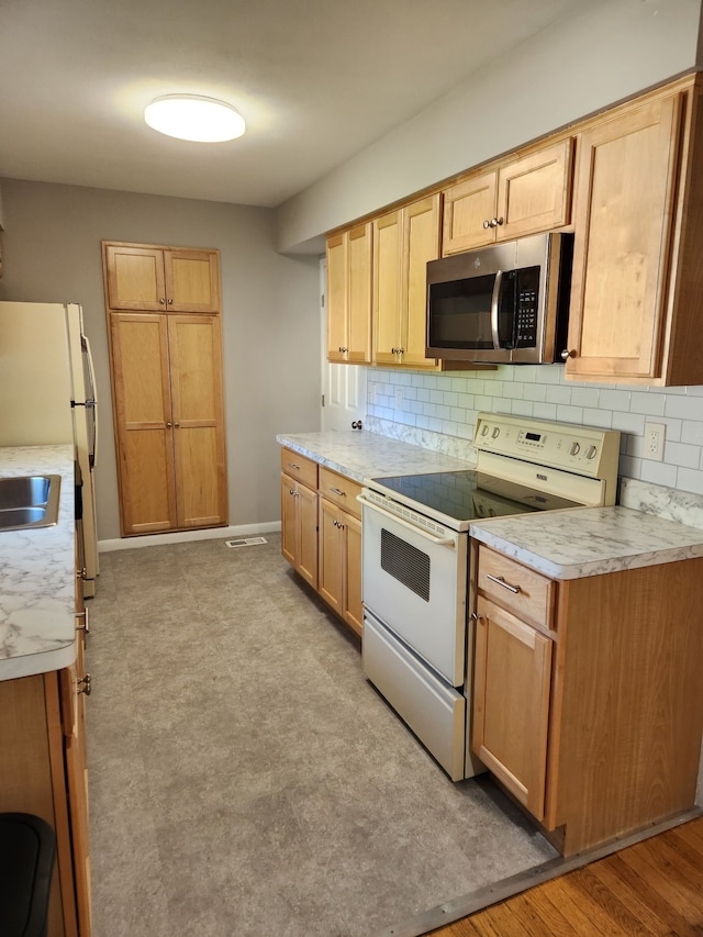 501 Virginia Ave, East Lansing, MI 48823 - kitchen with white appliances, tasteful backsplash, and light countertops