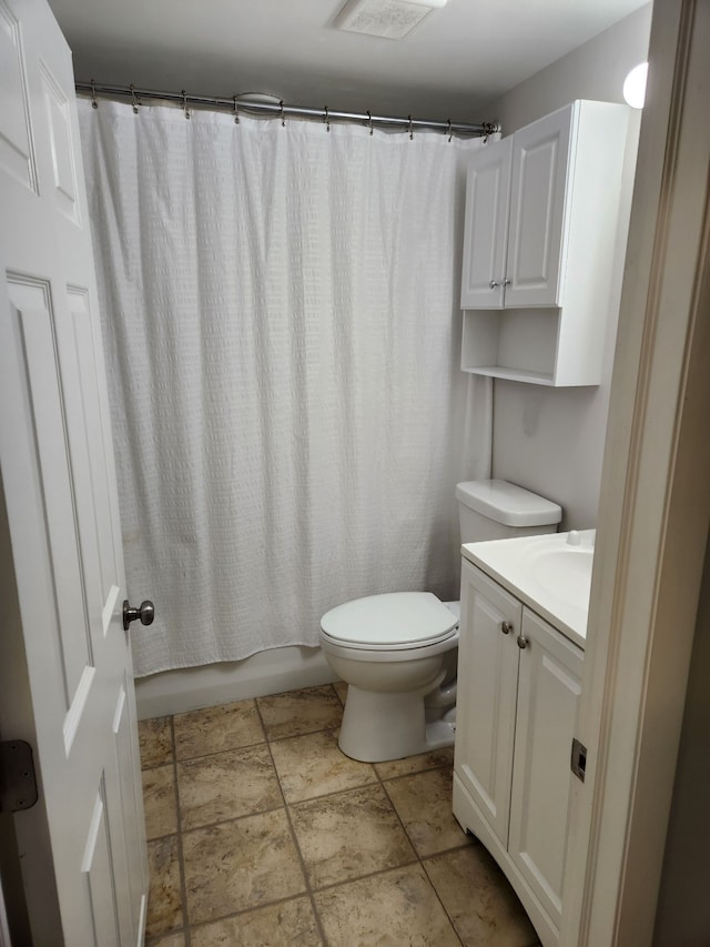 501 Virginia Ave, East Lansing, MI 48823 - full bath featuring toilet, vanity, shower / bathtub combination with curtain, and stone finish flooring