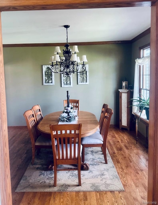 3217 Autumn View Ln, Metamora, MI 48455 - dining room with a chandelier, crown molding, and wood finished floors