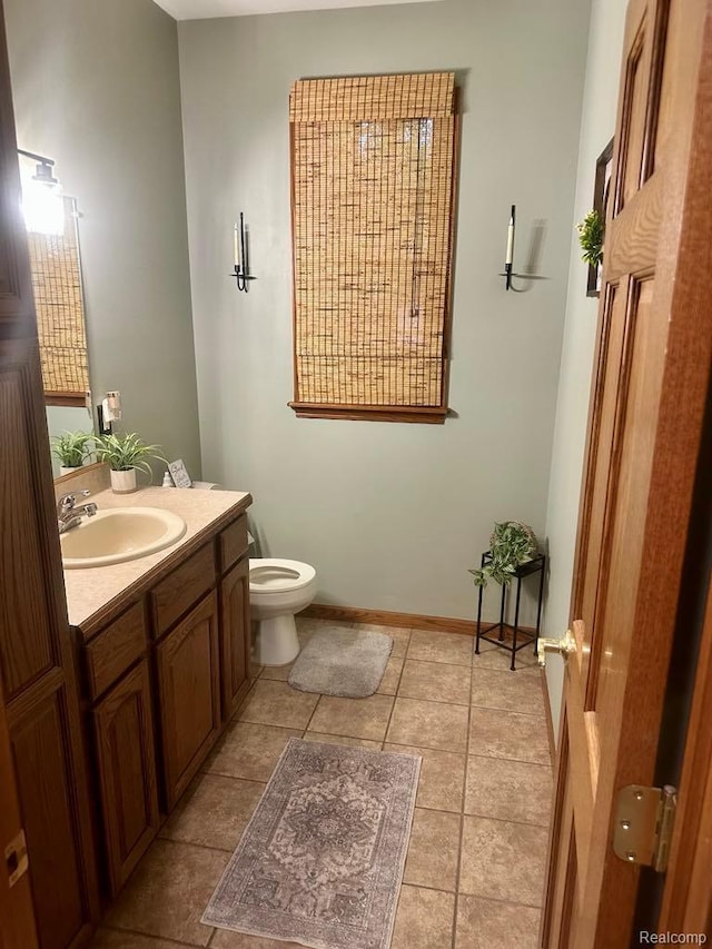 3217 Autumn View Ln, Metamora, MI 48455 - bathroom featuring vanity, toilet, tile patterned floors, and baseboards