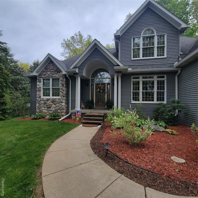 3217 Autumn View Ln, Metamora, MI 48455 - view of front of home featuring a front lawn, stone siding, and a shingled roof
