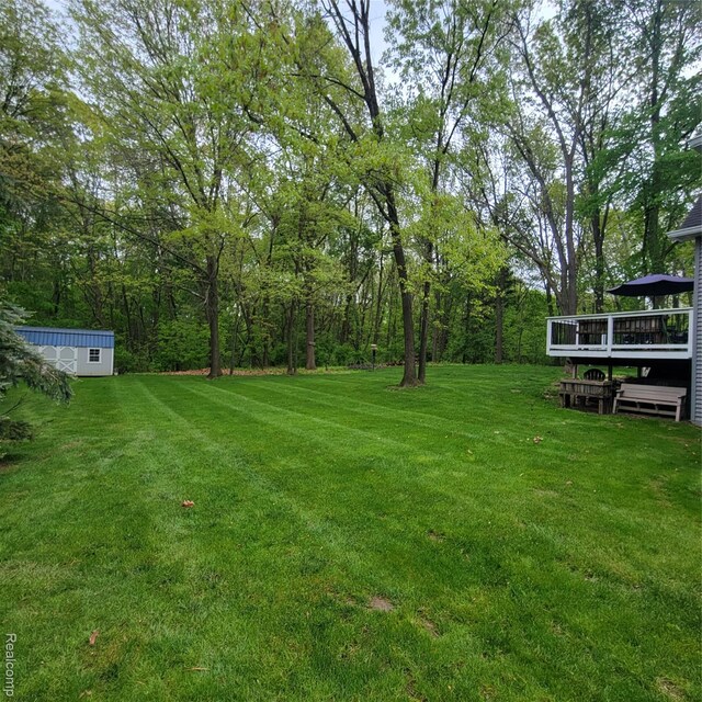 3217 Autumn View Ln, Metamora, MI 48455 - view of grassy yard with a deck and an outbuilding