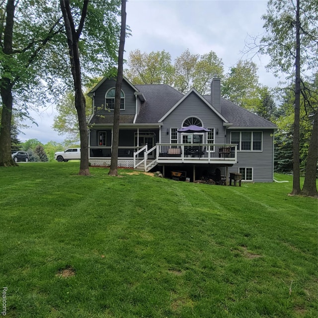 3217 Autumn View Ln, Metamora, MI 48455 - back of house featuring a wooden deck, a lawn, a chimney, and roof with shingles