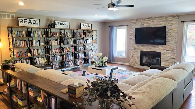 6192 N Shore Dr, West Bloomfield, MI 48324 - living room with wood finished floors, ceiling fan, baseboards, and a fireplace