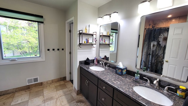 6192 N Shore Dr, West Bloomfield, MI 48324 - full bath with baseboards, double vanity, curtained shower, and stone finish flooring