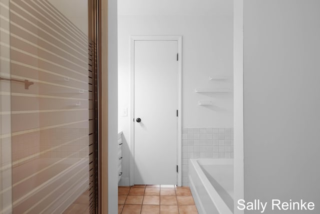 16972 James Dr, Big Rapids, MI 49307 - bathroom with a bath and tile patterned floors
