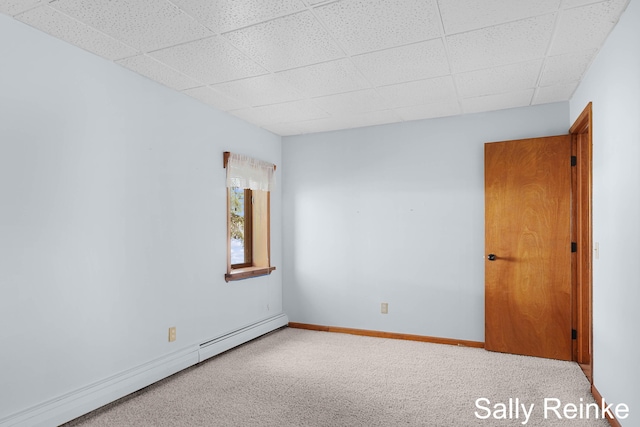 16972 James Dr, Big Rapids, MI 49307 - carpeted spare room featuring a baseboard heating unit, a drop ceiling, and baseboards