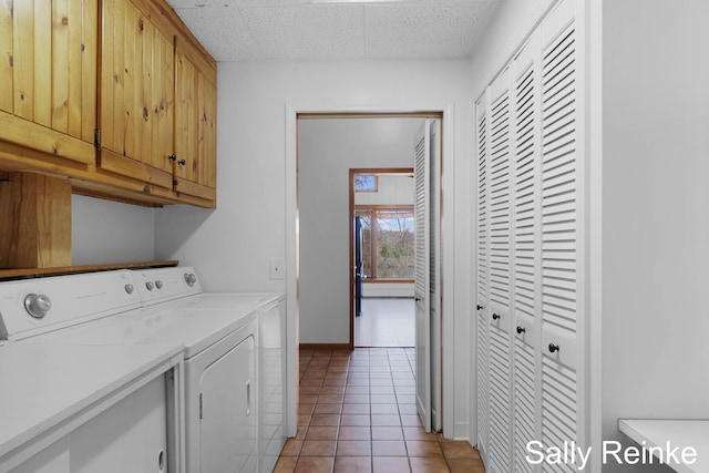 16972 James Dr, Big Rapids, MI 49307 - washroom featuring independent washer and dryer, cabinet space, light tile patterned floors, and baseboards