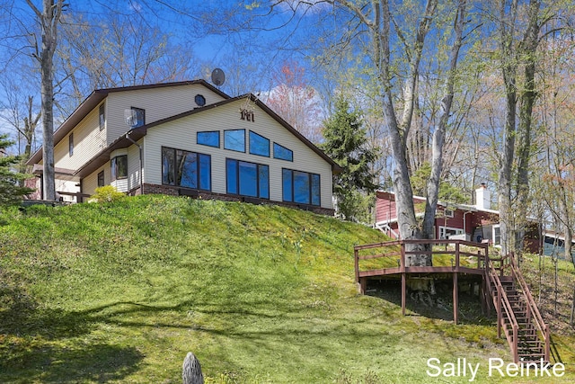 16972 James Dr, Big Rapids, MI 49307 - rear view of house with a wooden deck and stairway