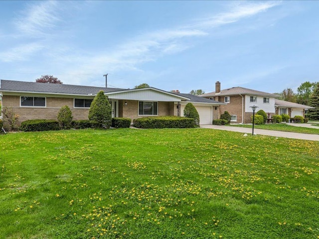 37305 Maas Dr, Sterling Heights, MI 48312 - single story home featuring a garage, brick siding, a front yard, and concrete driveway