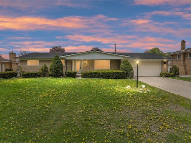 37305 Maas Dr, Sterling Heights, MI 48312 - ranch-style home featuring a garage, a lawn, brick siding, and concrete driveway
