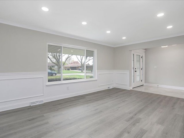 37305 Maas Dr, Sterling Heights, MI 48312 - spare room featuring crown molding, recessed lighting, wainscoting, light wood finished floors, and a decorative wall