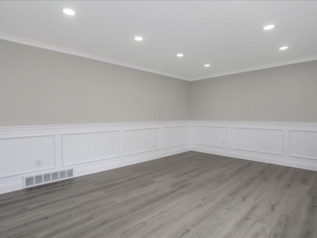 37305 Maas Dr, Sterling Heights, MI 48312 - spare room featuring recessed lighting, ornamental molding, a decorative wall, a wainscoted wall, and wood finished floors