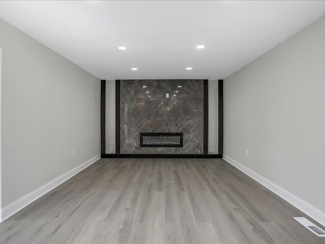 37305 Maas Dr, Sterling Heights, MI 48312 - unfurnished living room with baseboards, recessed lighting, wood finished floors, and a premium fireplace