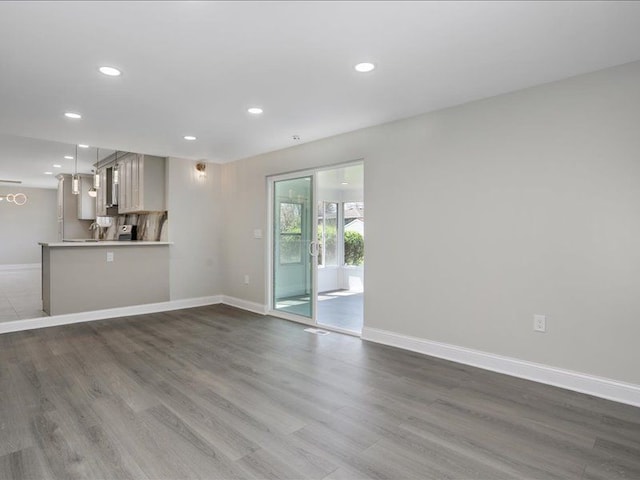 37305 Maas Dr, Sterling Heights, MI 48312 - unfurnished living room with recessed lighting, dark wood finished floors, and baseboards