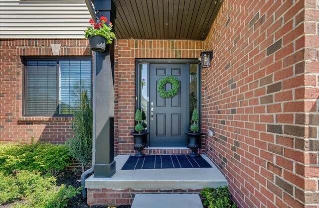 5134 Muirfield Ln, Clarkston, MI 48348 - view of exterior entry featuring brick siding and covered porch