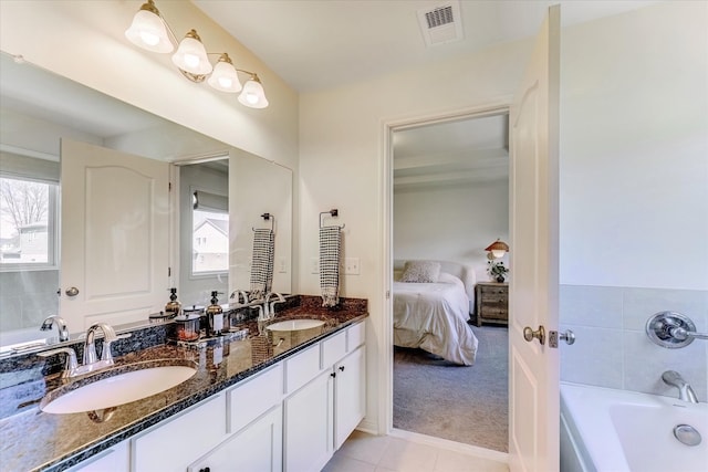 5134 Muirfield Ln, Clarkston, MI 48348 - ensuite bathroom with a bathtub, tile patterned floors, and double vanity