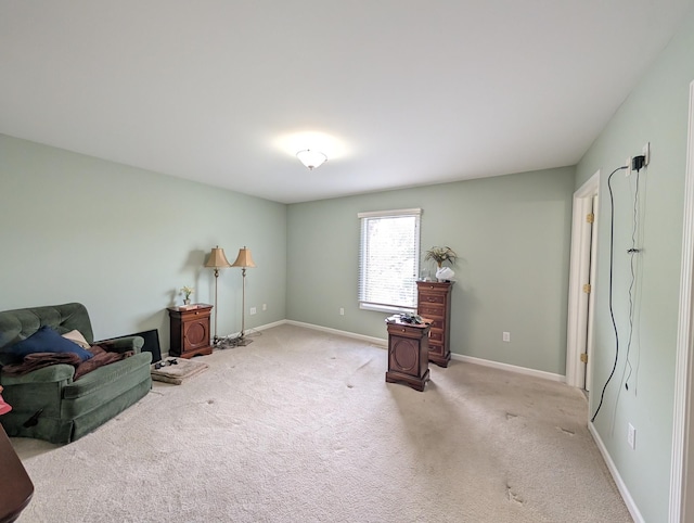 sitting room featuring carpet flooring and baseboards