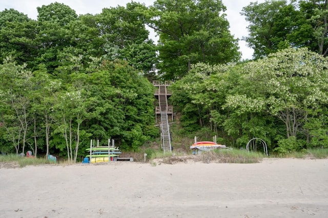 view of community featuring stairs and view of scattered trees