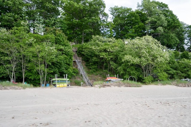 surrounding community with view of wooded area and stairway