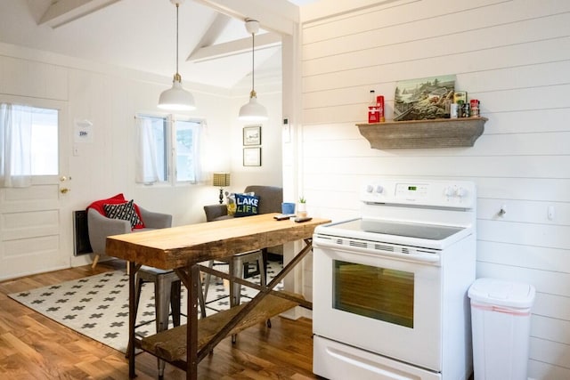 kitchen featuring electric stove, wood finished floors, wooden walls, and decorative light fixtures
