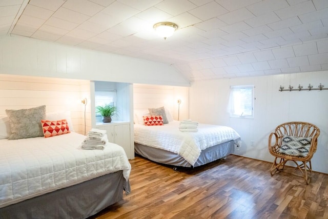 bedroom featuring vaulted ceiling and wood finished floors