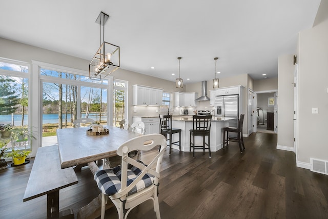 153 Tippi Trl, Buckley, MI 49620 - dining room with dark wood-style floors, baseboards, recessed lighting, and a water view
