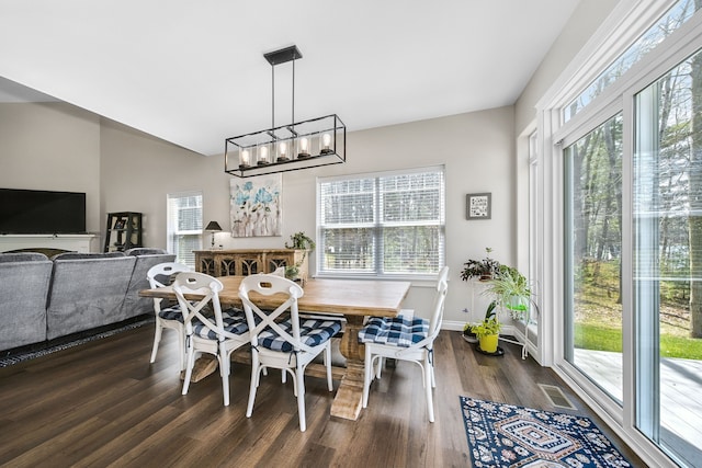 153 Tippi Trl, Buckley, MI 49620 - dining area featuring dark wood-style floors, baseboards, a chandelier, and lofted ceiling