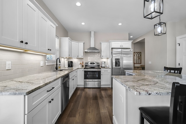 153 Tippi Trl, Buckley, MI 49620 - kitchen featuring appliances with stainless steel finishes, wall chimney range hood, a sink, dark wood-style flooring, and white cabinets