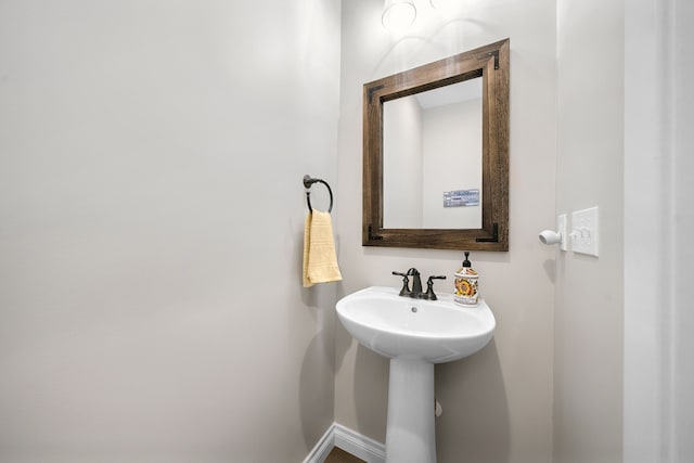 153 Tippi Trl, Buckley, MI 49620 - bathroom featuring baseboards and a sink