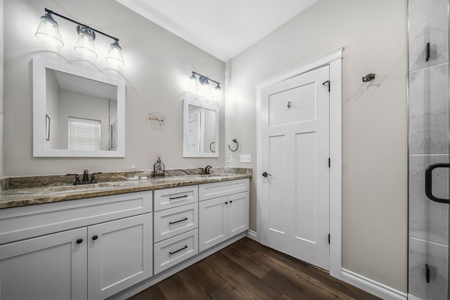 153 Tippi Trl, Buckley, MI 49620 - full bath featuring wood finished floors, double vanity, a stall shower, and baseboards