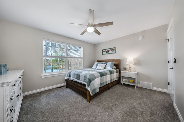153 Tippi Trl, Buckley, MI 49620 - bedroom featuring baseboards, dark colored carpet, and a ceiling fan