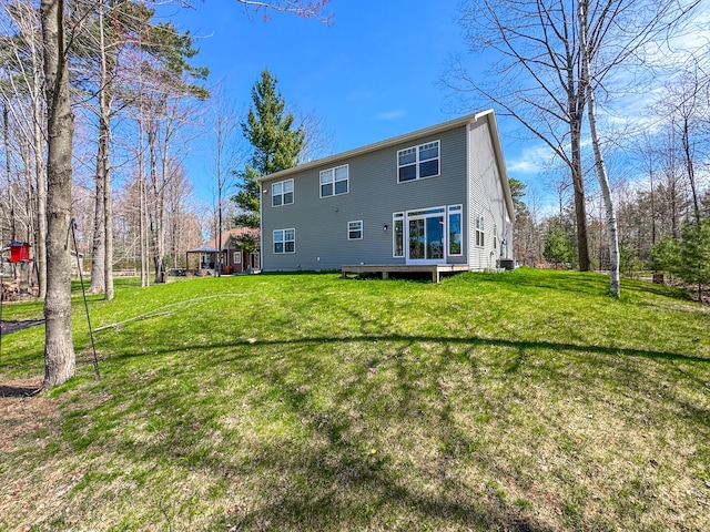 153 Tippi Trl, Buckley, MI 49620 - back of house featuring a lawn