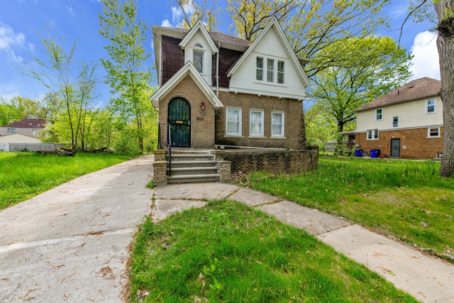 3835 Courville St, Detroit, MI 48224 - view of front of property featuring brick siding, a front lawn, and concrete driveway