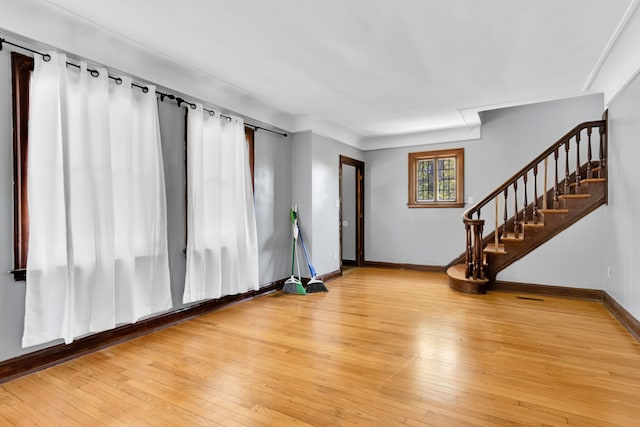 3835 Courville St, Detroit, MI 48224 - unfurnished living room with stairway, light wood-type flooring, and baseboards