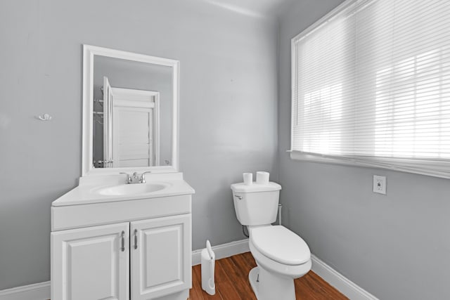 3835 Courville St, Detroit, MI 48224 - half bath featuring vanity, wood finished floors, toilet, and baseboards