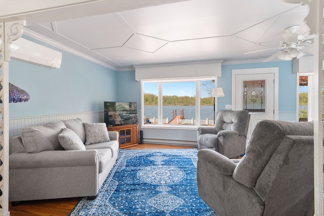 5303 Lake Rd, Reading, MI 49274 - living area featuring wood finished floors, a wainscoted wall, ornamental molding, baseboard heating, and a wall unit AC