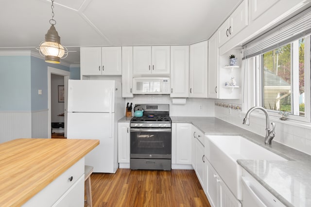 5303 Lake Rd, Reading, MI 49274 - kitchen featuring white appliances, white cabinetry, hanging light fixtures, dark wood-style floors, and decorative backsplash