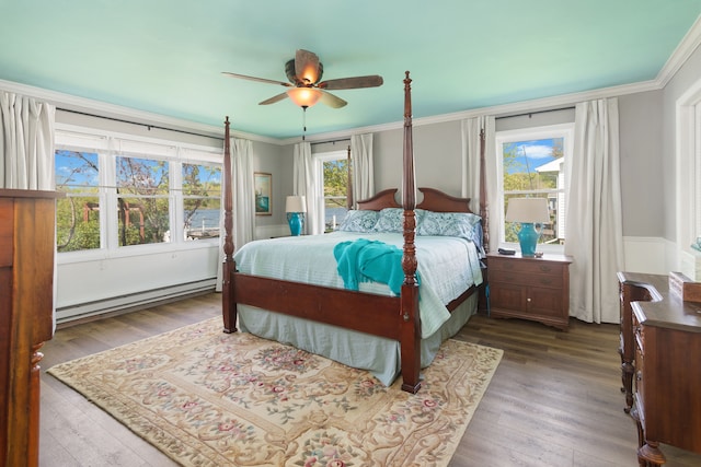 5303 Lake Rd, Reading, MI 49274 - bedroom with baseboard heating, multiple windows, ornamental molding, wood finished floors, and a ceiling fan