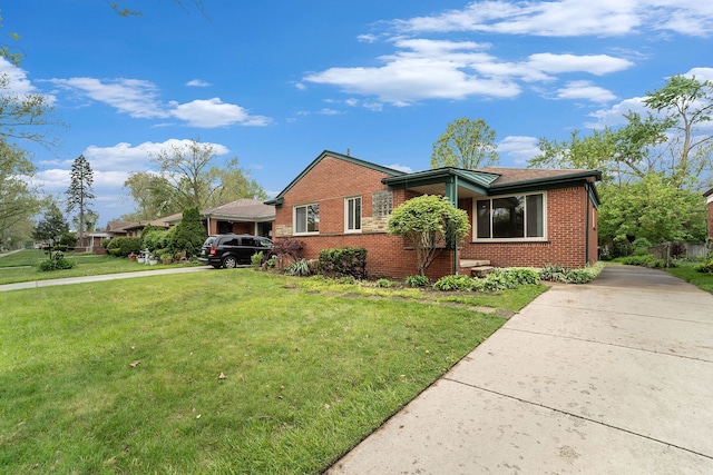 view of front of house featuring brick siding, concrete driveway, and a front lawn