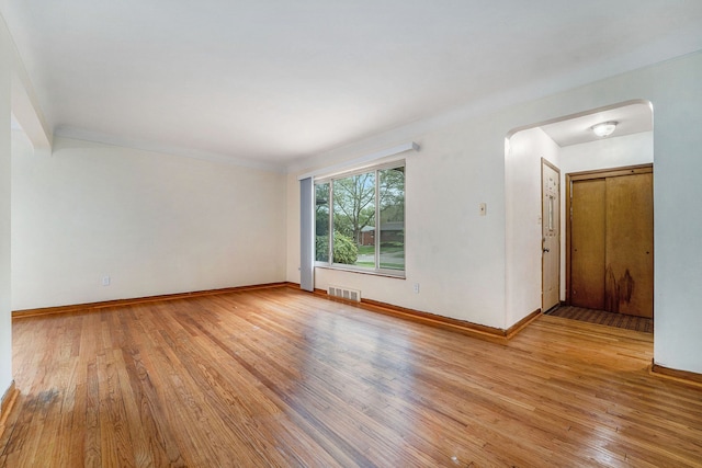 spare room with light wood-type flooring and baseboards
