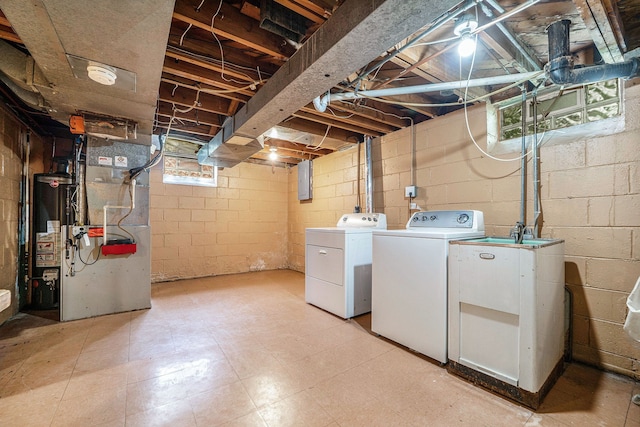 laundry room with independent washer and dryer, gas water heater, and heating unit