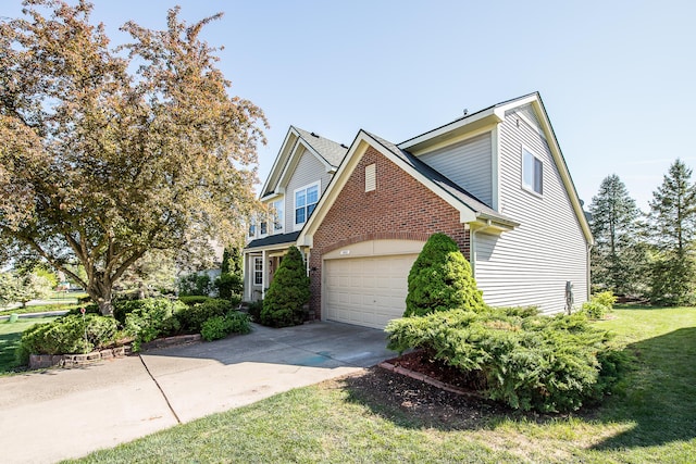 1953 Harley Ct, Ann Arbor, MI 48103 - traditional-style home with a garage, concrete driveway, a front yard, and brick siding