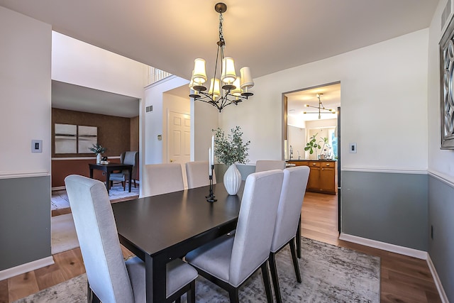 1953 Harley Ct, Ann Arbor, MI 48103 - dining space with a chandelier, wood finished floors, and baseboards