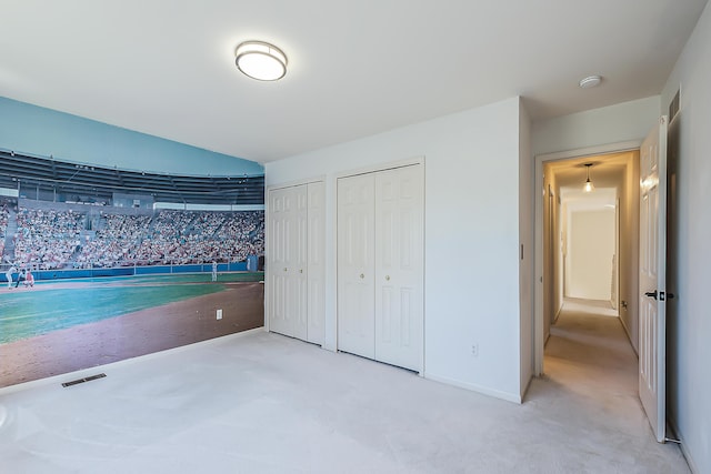 1953 Harley Ct, Ann Arbor, MI 48103 - unfurnished bedroom featuring multiple closets, carpet flooring, and baseboards