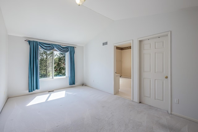 1953 Harley Ct, Ann Arbor, MI 48103 - unfurnished bedroom with vaulted ceiling, carpet floors, connected bathroom, and baseboards